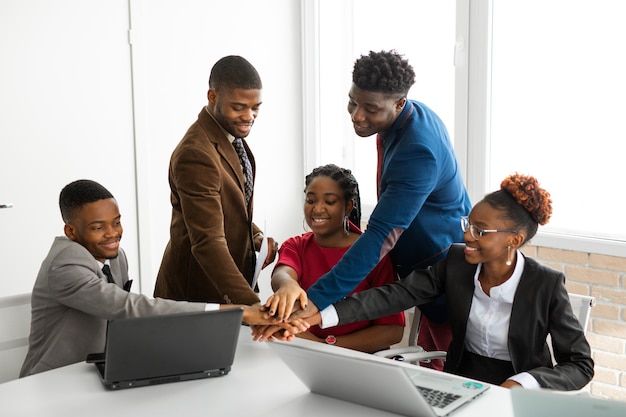 Diverse team shaking hands in a modern office setting